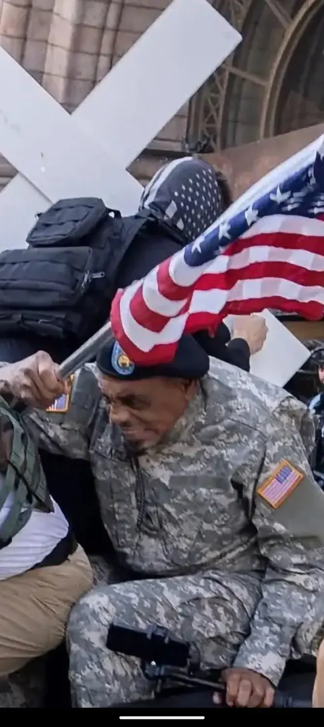 Guy in a military uniform that I assume to be national guard (could be wrong), ducking away and pulling a nasty grimace stank face that reminds me of Gargamel from the smurfs