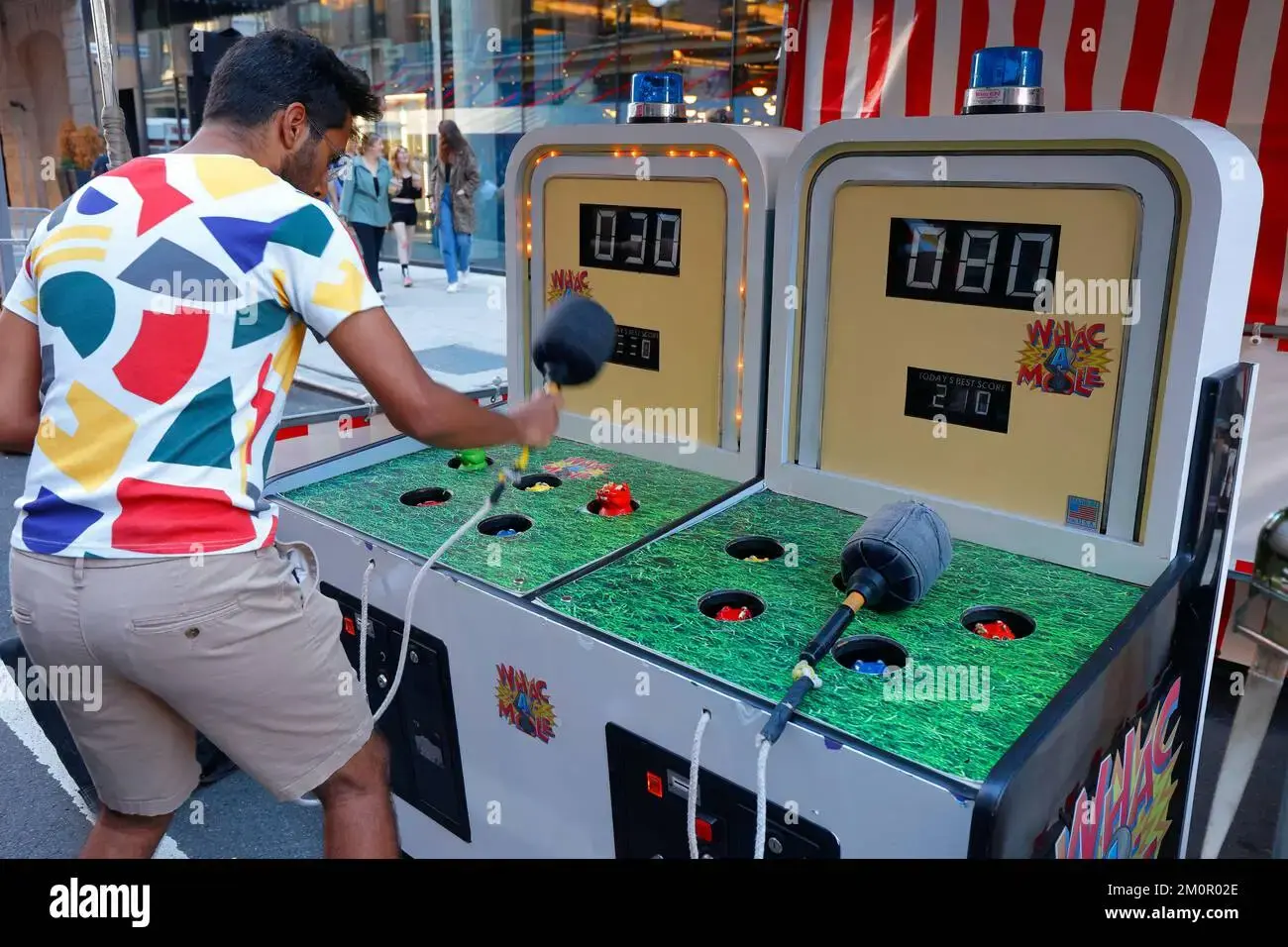 Person plays Wack A Mole game
