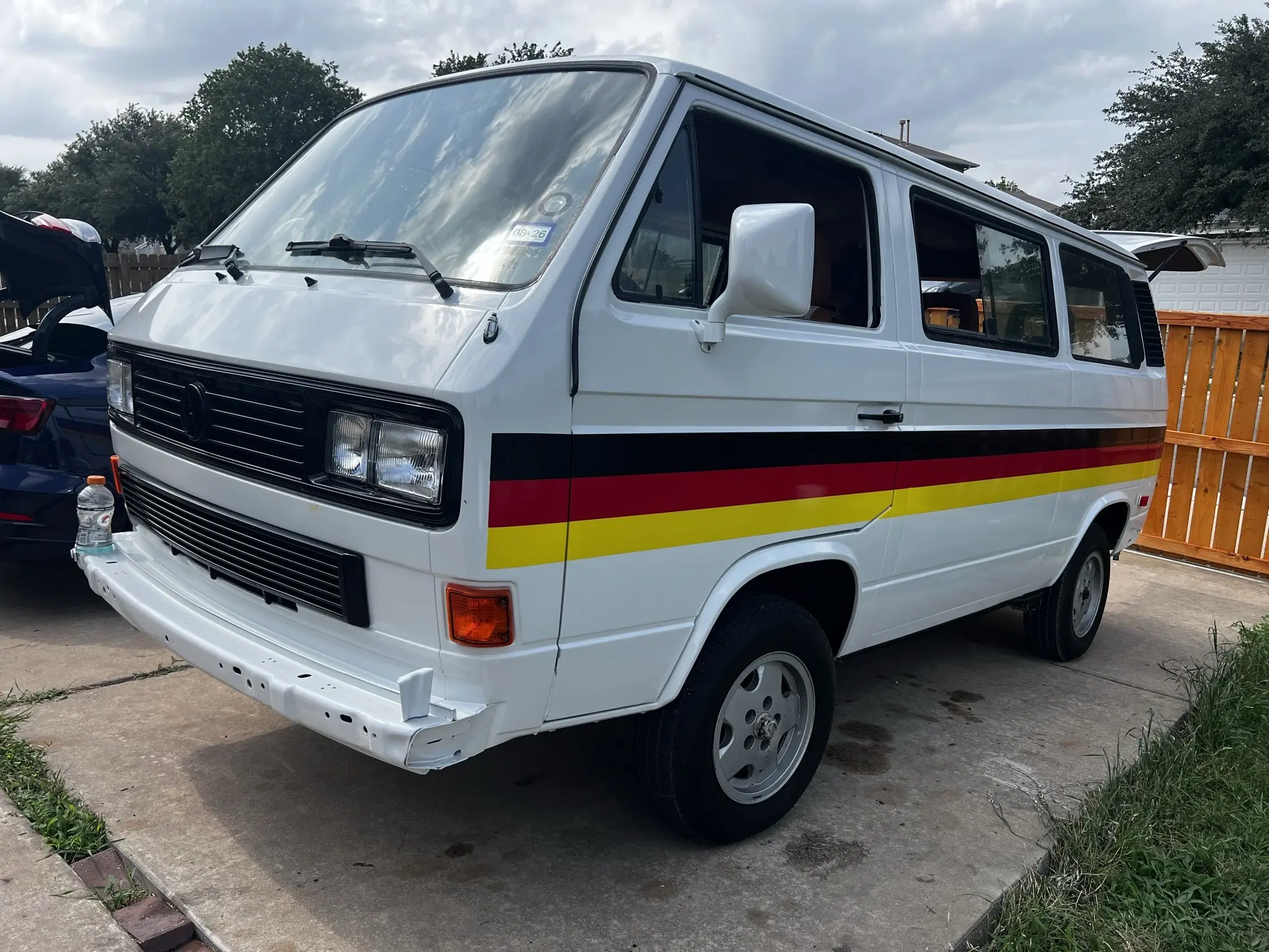 A 1990 Volkswagen Vanagon with a German flag livery