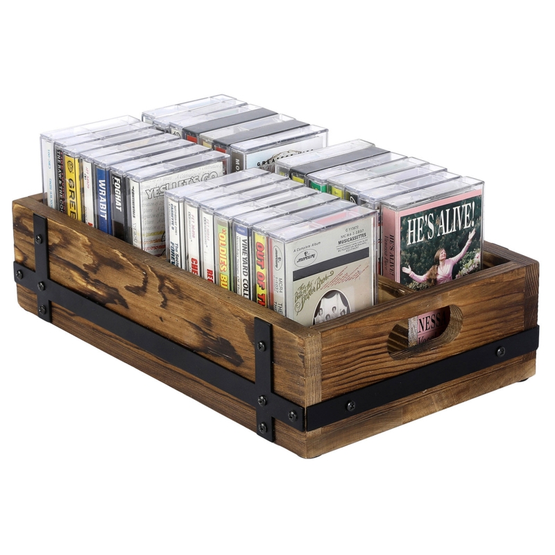 A solid wood box holding a variety of palm-sized cassette tapes.