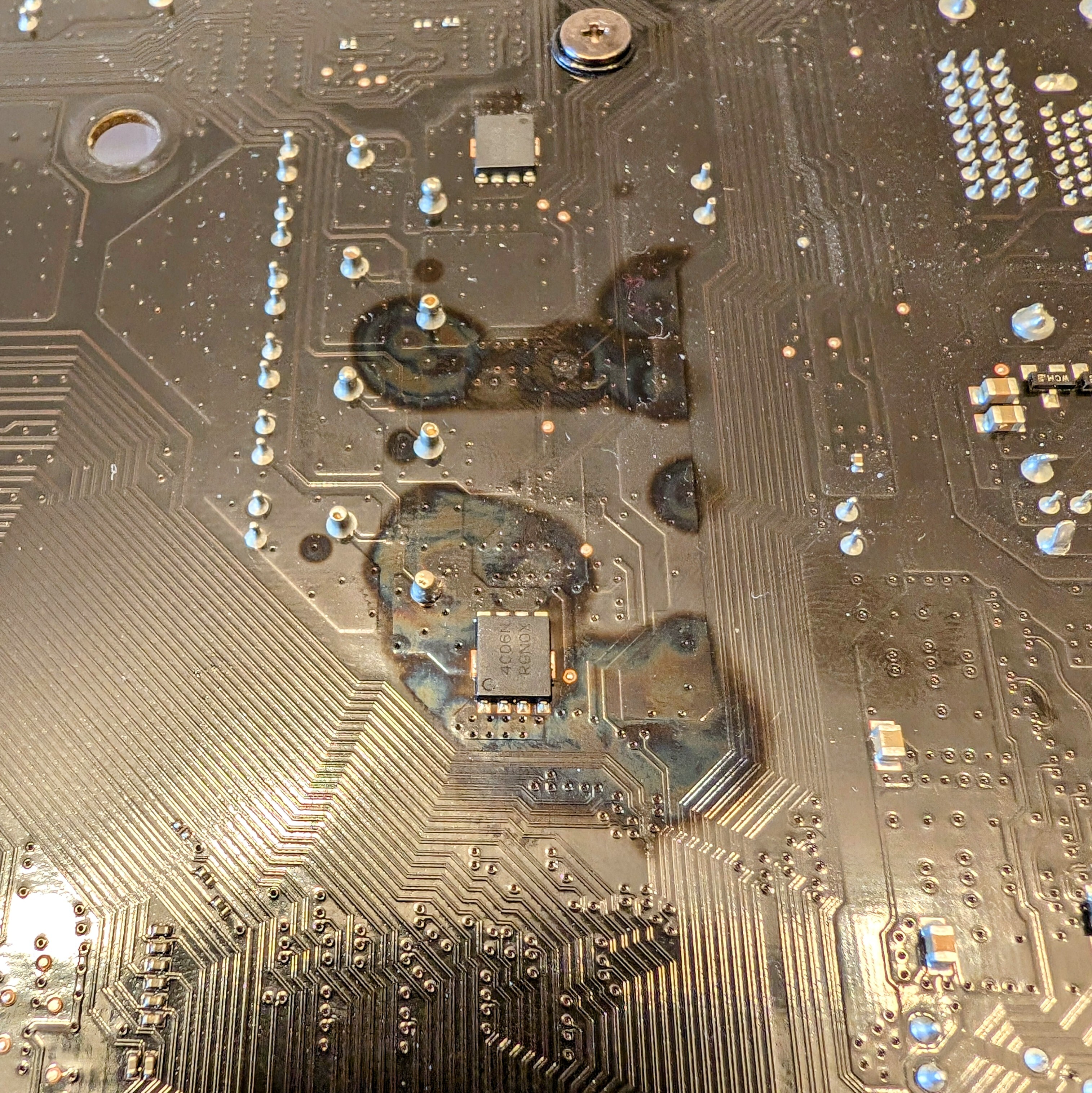 a discolored spot on a motherboard located under the VRM